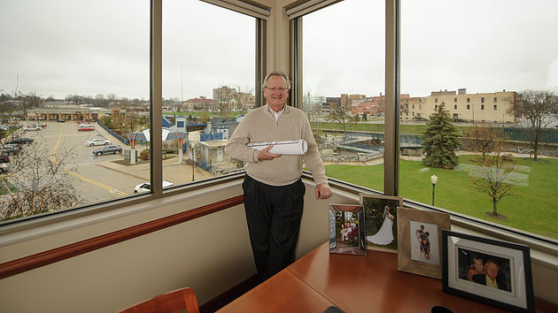Tom Borger enjoys a panoramic view of downtown Elkhart from his office at 200 NIBCO Parkway. Photo by Jason Bryant.